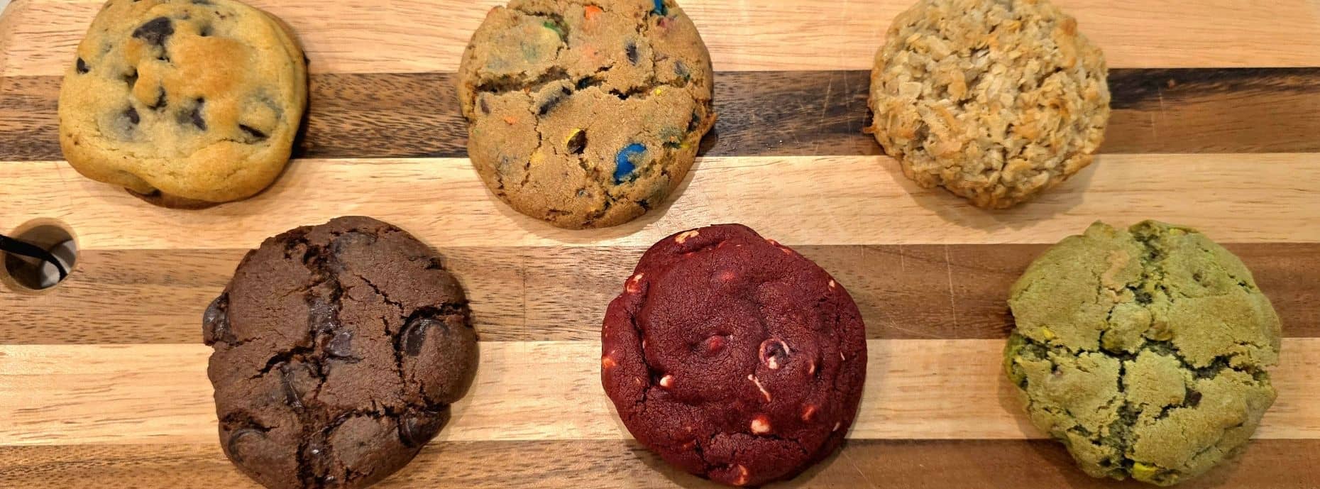 Assorted signature cookies on a wooden board